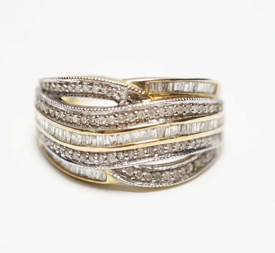 A modern 9ct gold and five row baguette and round cut diamond cluster set half hoop dress ring, size P, gross weight 4.5 grams.